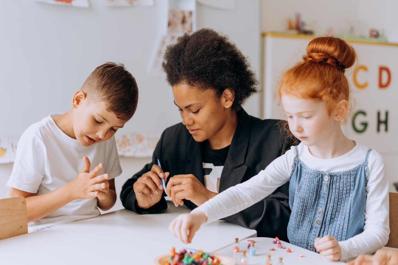 services-01 Teacher engaging with children in a classroom setting, fostering learning and creativity.