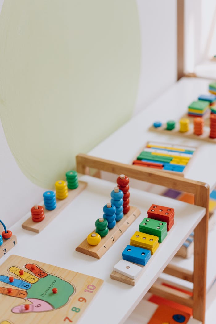 services-03 Bright and colorful educational wooden toys displayed on a table in a classroom.